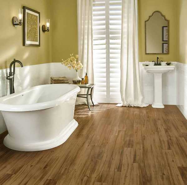 traditional bathroom with wood look flooring and soaker tub